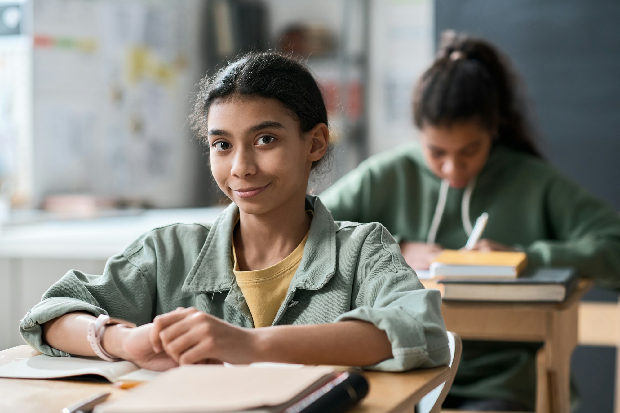 Schoolgirl sitting at desk in the classroom